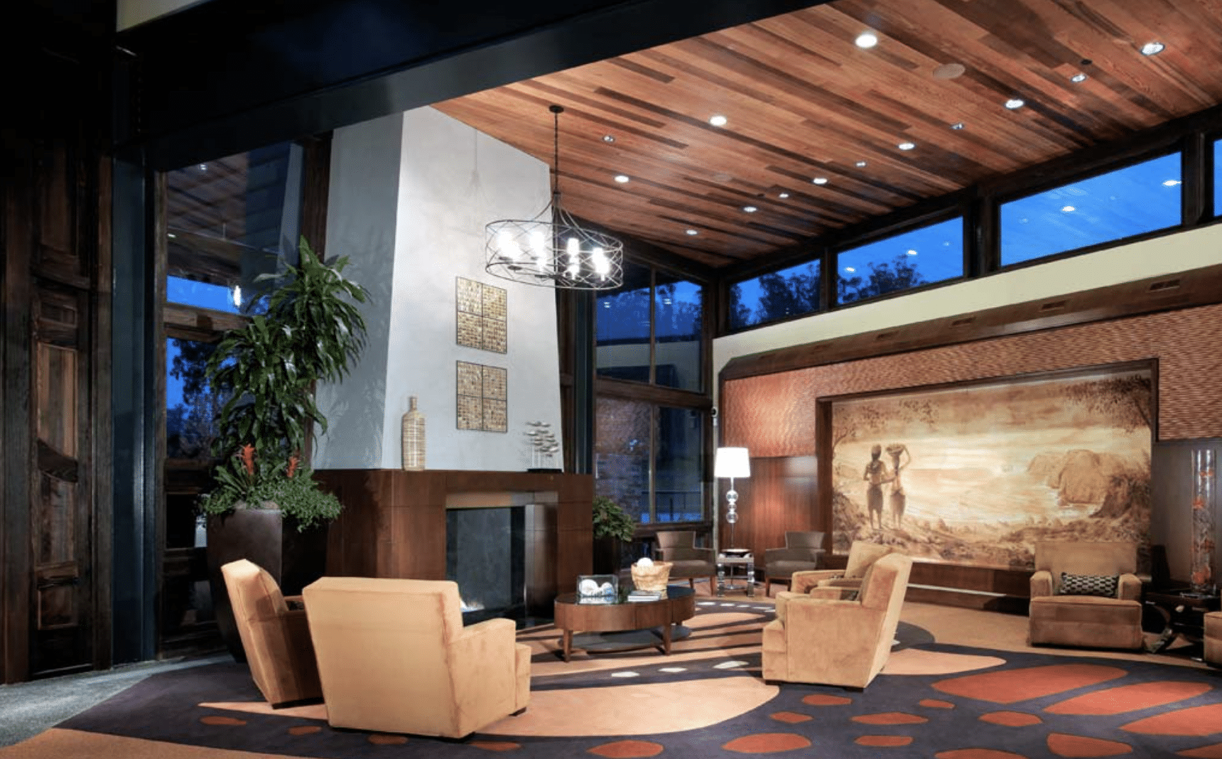 Modern mountain lodge with wood ceiling and cozy furniture.